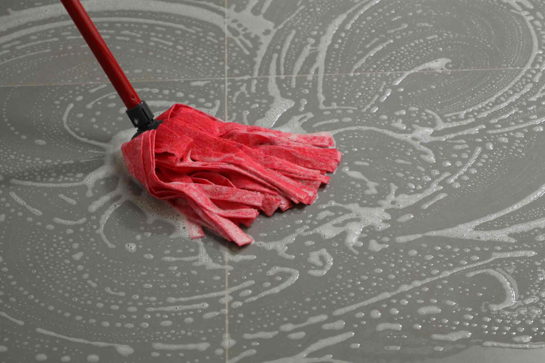 Mopping the floor tiles. Cleaning the floor tiles with mop,housework in kitchen